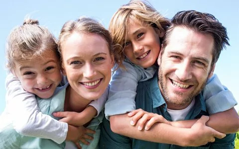 Smiling family with kids outside received general dentistry care in Longview, TX