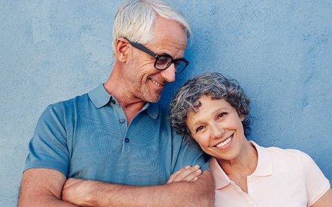 Man looking at wife smiling with new dental implants in Texas