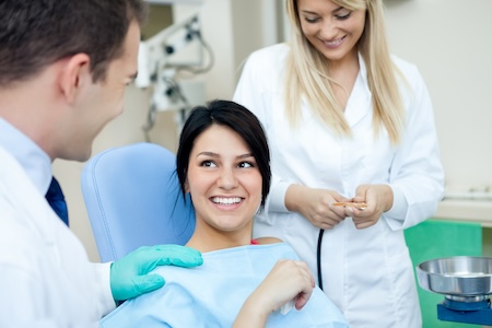 woman in exam chair discussing treatment