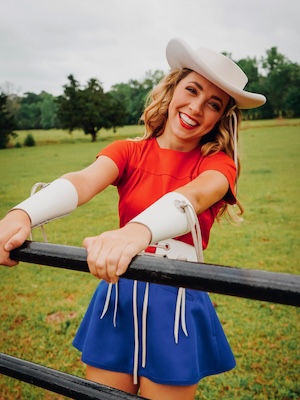 texas woman smiling by fence