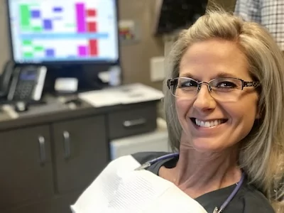 Longview dental implants patient smiles while visiting Vaca and Kirby Dental