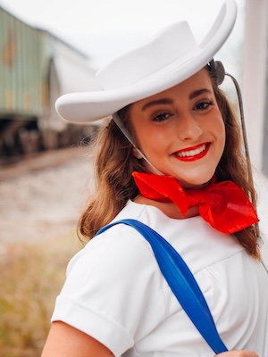 texas woman with dark hair smiling with straight teeth from Invisalign