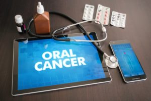 Stethoscope on top of a tablet displaying the words "oral cancer"