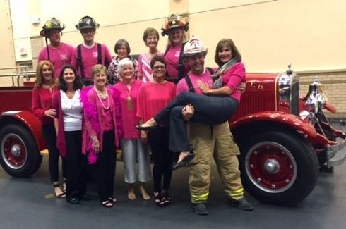 Firemen posing with the Vaca & Kirby Dental group